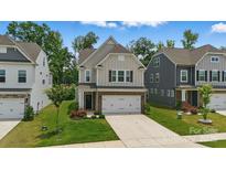 Charming two-story home with a well-maintained lawn and a two-car garage on a sunny day at 3899 Center Place Dr, Harrisburg, NC 28075