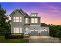 Charming two-story home featuring a welcoming light-blue front door and a convenient two-car garage at 531 Harlech Ct, Fort Mill, SC 29715