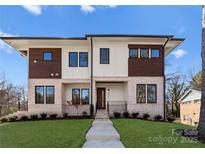 Modern two-story home featuring a brick facade, dark trim, and a well-manicured lawn at 5520 Chedworth Dr, Charlotte, NC 28210