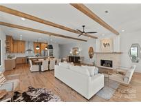 Spacious living area with a modern fireplace, hardwood floors, and an open floor plan at 5520 Chedworth Dr, Charlotte, NC 28210