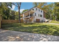 Beautifully designed two-story home with a large yard, fenced-in area, and a private driveway at 5610 Farmbrook Dr, Charlotte, NC 28210