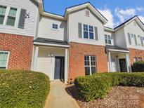 Traditional two-story townhouse showcasing brick and siding, with a well-maintained front yard at 6466 Mallard View Ln, Charlotte, NC 28269