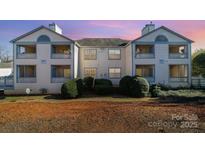 Multi-unit building showcasing clean architectural design, with well-maintained landscaping at 8024 Tremaine Ct # D, Charlotte, NC 28227