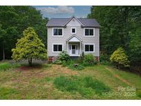 Charming two-story home featuring large windows and a welcoming front porch at 946 Laurelwood Dr, Clover, SC 29710