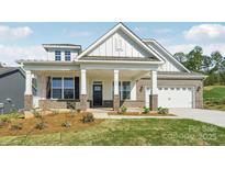 Inviting exterior with covered porch, brick accents, and two-car garage enhance this charming home at 237 Miramar Dr, York, SC 29745