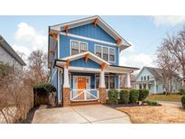 Charming two-story home featuring a blue exterior, orange accents, and a welcoming front porch at 331 Solomon St, Charlotte, NC 28216