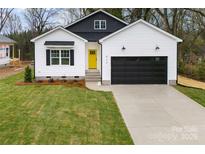 Charming new construction home featuring a black garage door and a bright yellow front door at 412 W Westview St, Gastonia, NC 28052