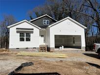 New construction home with white siding, dark gray accent, and an attached two-car garage at 412 W Westview St, Gastonia, NC 28052