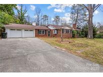 Charming brick home with a two-car garage, a long driveway, and a well-manicured front yard at 121 Ne 33Rd Ave, Hickory, NC 28601
