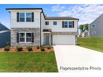 Two-story home featuring white siding, stone accents, a two-car garage, and manicured landscaping at 156 Tangle River Dr # 35, Statesville, NC 28677