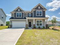 Beautiful two-story home featuring a two-car garage and a well-manicured lawn at 2211 Camber Dr # Cwo0103, Gastonia, NC 28054