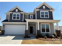 Charming two-story home with gray siding, white trim, brick accents, and a welcoming front porch at 2211 Camber Dr # Cwo0103, Gastonia, NC 28054