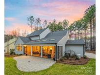 A covered patio and lush lawn highlight this home's spacious backyard at 3288 Sherman Dr, Lancaster, SC 29720