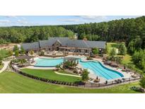Aerial view of neighborhood pool and clubhouse surrounded by lush green landscaping at 3288 Sherman Dr, Lancaster, SC 29720