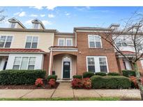 Charming brick townhome featuring a well-maintained lawn and inviting entryway at 8409 Scotney Bluff Ave, Charlotte, NC 28273