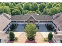 Stunning aerial view of a multi-unit property featuring a circular driveway and lush green landscaping at 8925 Rosalyn Glen Rd, Cornelius, NC 28031