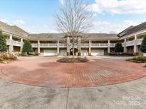 Charming condo building with brick drive, manicured landscaping and private garages at 8925 Rosalyn Glen Rd, Cornelius, NC 28031