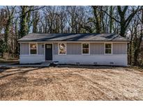 Charming renovated single-story home featuring new windows and a freshly painted exterior at 1522 Wickham Ln, Charlotte, NC 28208