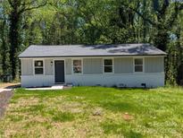 Charming single-story home with freshly painted exterior and a well-manicured lawn at 1522 Wickham Ln, Charlotte, NC 28208