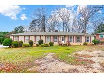 Charming brick ranch home with well-maintained landscaping and classic shutters at 1800 E Garrison Blvd, Gastonia, NC 28054