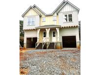 Unfinished two story duplex features double front entryways and garage doors awaiting customization at 2526 Elkwood Cir, Charlotte, NC 28205