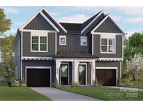 Charming two-story townhome with a modern gray and white exterior and well-manicured front lawn at 2526 Elkwood Cir, Charlotte, NC 28205
