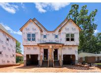 New two-story home under construction featuring covered porch and multiple windows at 2526 Elkwood Cir, Charlotte, NC 28205