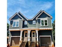 New construction duplex with charcoal siding, white trim, garage doors, and shared front stairs at 2526 Elkwood Cir, Charlotte, NC 28205