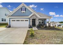 Charming single-Gathering home with a two-car garage, stone accents, and a well-manicured lawn at 5239 Admirals Lndg, Lancaster, SC 29720