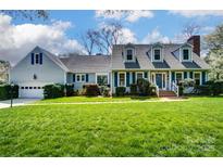 Charming two-story home with a manicured lawn and blue shutters at 1207 Chadbourne Ave, Concord, NC 28027