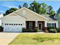 Charming single-story home with a two car garage, manicured lawn and inviting front porch and red brick exterior at 1726 Still River Way, Fort Mill, SC 29708