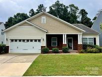 Charming single-Gathering home featuring manicured lawn, attached two car garage, and inviting front porch at 1726 Still River Way, Fort Mill, SC 29708