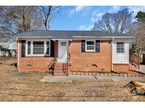 Charming brick home with black shutters and a well-maintained lawn at 511 Piedmont Ave, Shelby, NC 28150