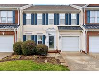 Charming townhouse with brick accents, blue shutters, and manicured landscaping at 618 Bayou Cir, Clover, SC 29710