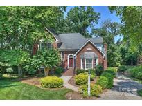 Charming brick home with a landscaped front yard and inviting walkway to the front door at 8000 Greencastle Dr, Charlotte, NC 28210