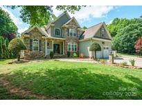 Charming two-story home with stone facade, manicured lawn, and well-maintained landscaping at 8143 Summit Ridge Dr # 41, Catawba, NC 28609