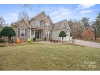 Inviting two-story home with a stone and siding exterior, manicured lawn, and a three-car garage at 8143 Summit Ridge Dr # 41, Catawba, NC 28609