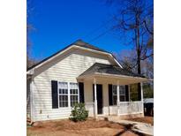 Charming single Gathering home with a covered porch, black shutters, and a white picket fence at 8900 Moores Chapel Rd, Charlotte, NC 28214