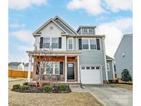 Charming two-story home with a well-manicured lawn and attached garage at 921 Von Buren Blvd, Rock Hill, SC 29730