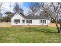 Charming single-story home with a well-maintained lawn and classic white siding at 1301 Martin Luther King Ave, Kannapolis, NC 28083