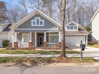 Charming home with a covered front porch, gray siding, and a two-car garage at 13245 Chelsea Ridge Ln, Huntersville, NC 28078