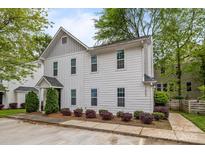 Charming two-story home featuring white siding, manicured landscaping, and a welcoming entrance at 1503 Briar Creek Rd # Apt B, Charlotte, NC 28205