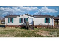 Charming single-story home featuring green shutters and a cozy front porch entry at 166 Sonja Dr, Statesville, NC 28677