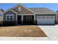 Charming single-story home showcasing a two-car garage, stone accents, neutral siding, and a well-maintained front yard at 2513 Crimson Way, Monroe, NC 28112