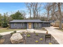 Charming renovated home featuring new landscaping, a modern painted exterior, and a welcoming front entrance at 608 Kenlough Dr, Charlotte, NC 28209