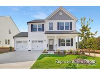 Charming two-story home featuring a two-car garage, a well-manicured lawn, and classic black window shutters at 731 Gondola Ct # 117, Salisbury, NC 28144