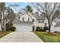 Charming two-story home featuring a two-car garage, well-maintained lawn, and a welcoming facade at 7713 Dunoon Ln, Charlotte, NC 28269
