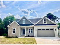 Charming single-Gathering home with a two-car garage, stone accents, and manicured lawn on a sunny day at 0 6Th Nw St, Hickory, NC 28601