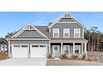 Beautiful two-story home with blue siding, white trim, and a welcoming front porch at 10053 Jack Nicklaus Dr # 932, Lancaster, SC 29720