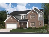 New construction home with a brick and gray siding exterior, two-car garage and manicured lawn at 103 Fallbrook Rd, Matthews, NC 28104
